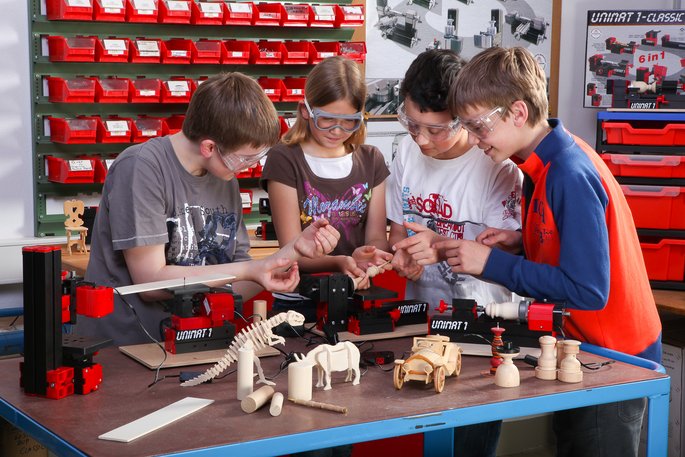 Schülerinnen und Schüler werken mit UNIMAT Maschinen